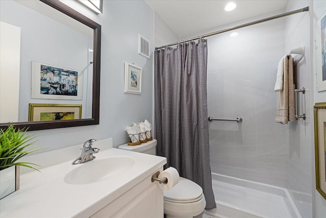 bathroom featuring vanity, curtained shower, and toilet