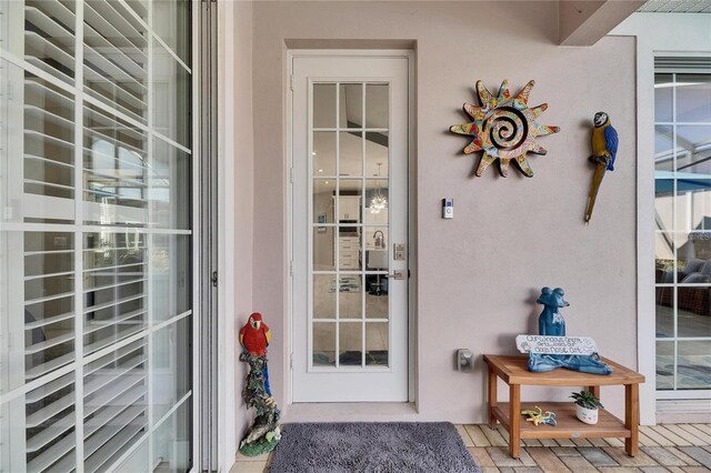 view of exterior entry with stucco siding