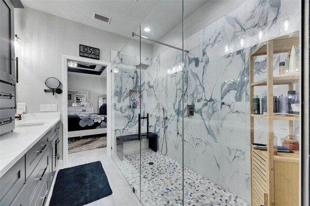 full bath with a marble finish shower, vanity, connected bathroom, and visible vents