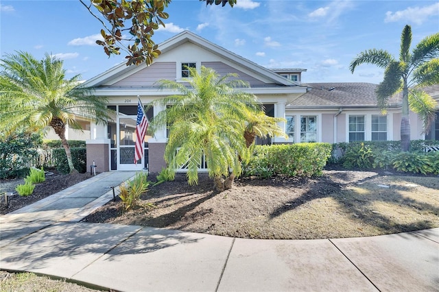 view of front of home featuring concrete driveway and stucco siding