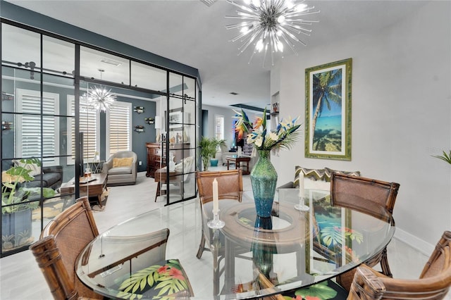 dining space with baseboards and an inviting chandelier