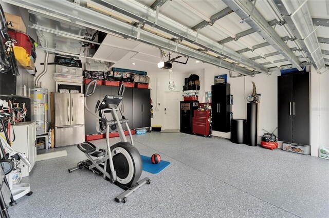 exercise area featuring a garage and gas water heater