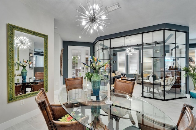 dining area featuring a notable chandelier and baseboards