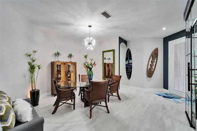 dining area with baseboards, visible vents, a chandelier, and a textured ceiling