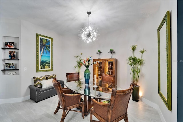 dining room with an inviting chandelier and baseboards