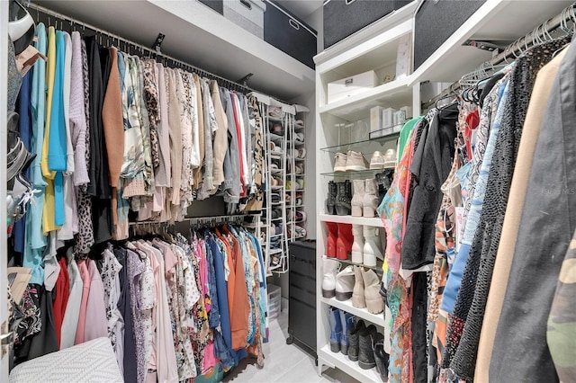 walk in closet with light tile patterned floors