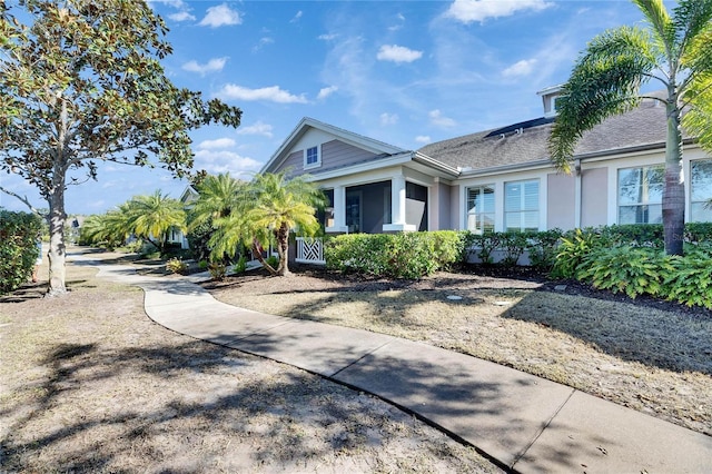 view of home's exterior with a sunroom and stucco siding