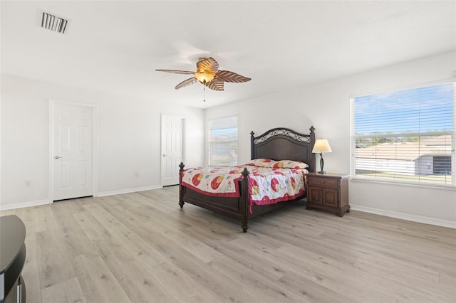 bedroom with multiple windows, ceiling fan, and light hardwood / wood-style flooring