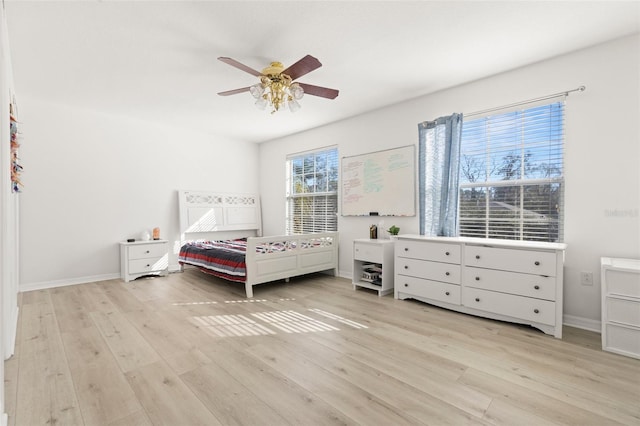 bedroom with ceiling fan and light wood-type flooring