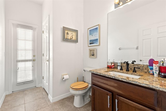 bathroom with vanity, tile patterned floors, and toilet