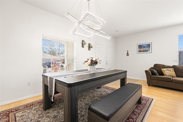 dining room featuring wood-type flooring and a notable chandelier