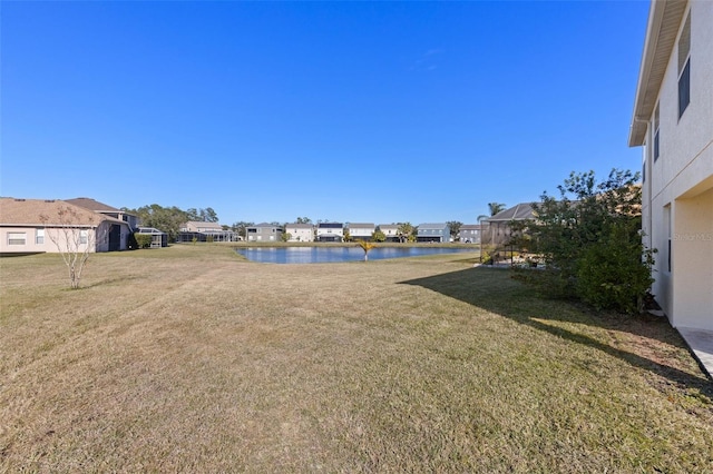 view of yard featuring a water view and a lanai