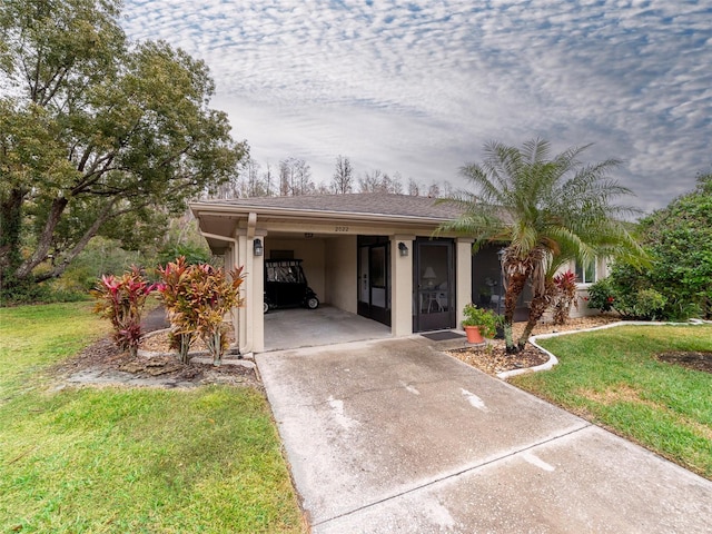 view of front facade with a front lawn and a carport