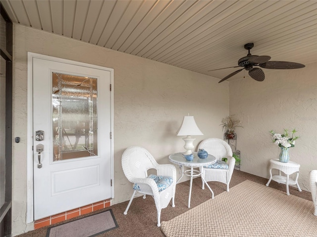 sunroom featuring ceiling fan