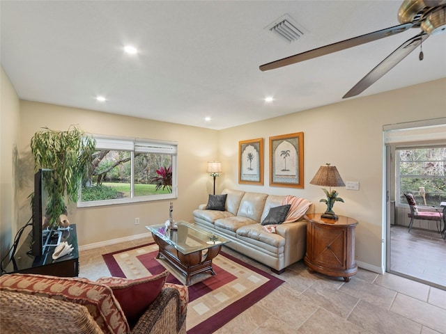 living room with ceiling fan and plenty of natural light