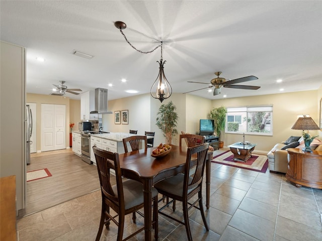 dining space with light tile patterned floors and ceiling fan