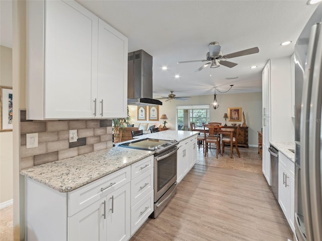 kitchen with white cabinetry, island range hood, and stainless steel appliances