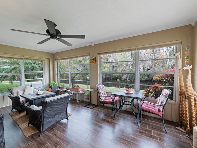 sunroom featuring ceiling fan