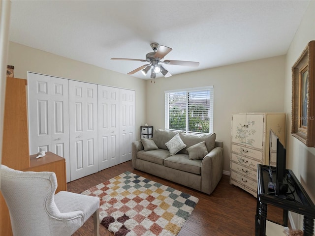 living room featuring dark hardwood / wood-style floors and ceiling fan