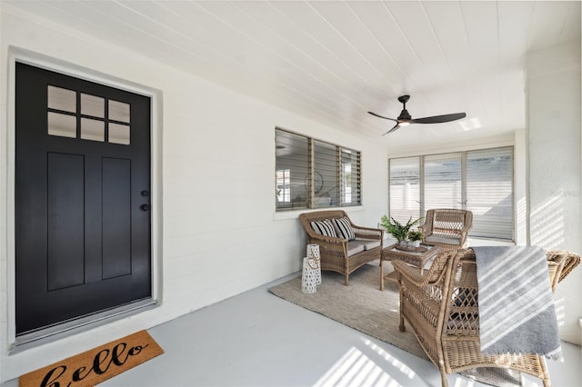 entrance to property featuring outdoor lounge area, ceiling fan, and covered porch