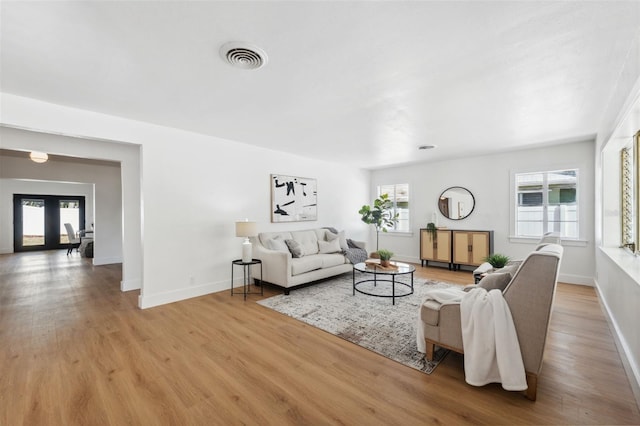 living room featuring plenty of natural light and light hardwood / wood-style floors