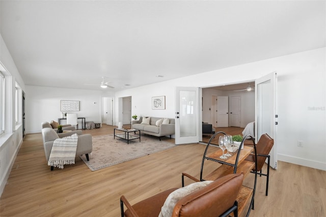 living room with ceiling fan and light wood-type flooring