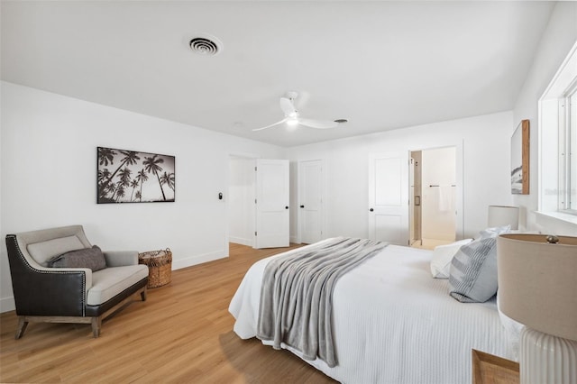 bedroom with hardwood / wood-style flooring, ceiling fan, and ensuite bathroom