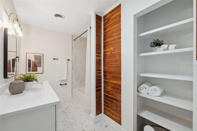 bathroom featuring vanity and  shower combination