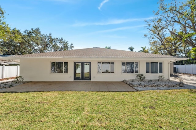 rear view of property featuring a yard and a patio