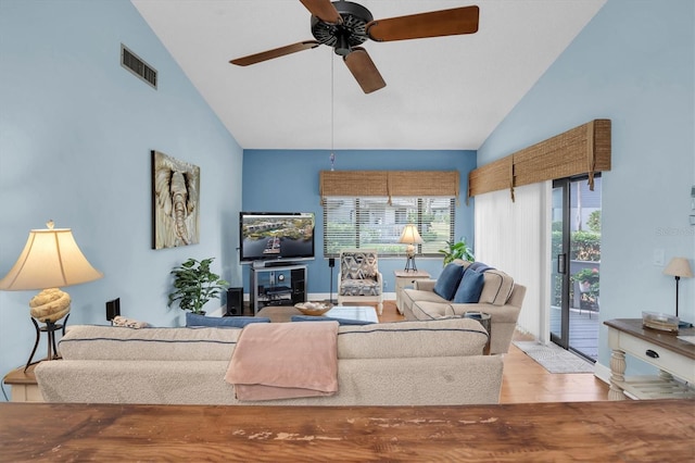 living room featuring ceiling fan, high vaulted ceiling, and light hardwood / wood-style flooring