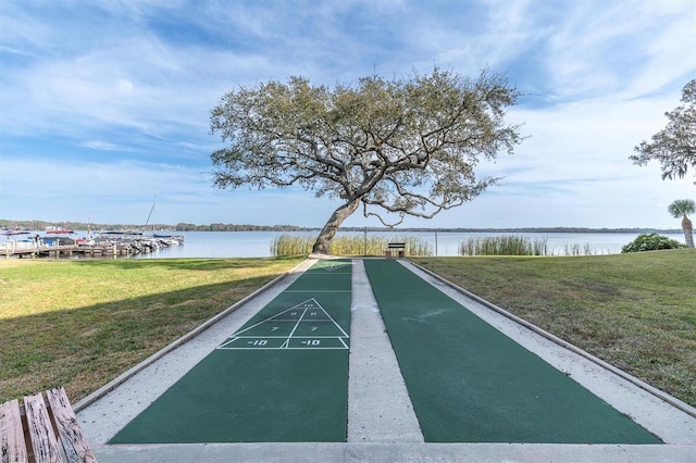 view of property's community with a yard and a water view