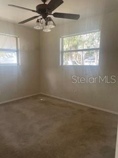 empty room with a healthy amount of sunlight and ceiling fan