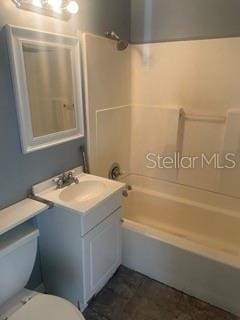 full bathroom featuring vanity, shower / tub combination, and toilet