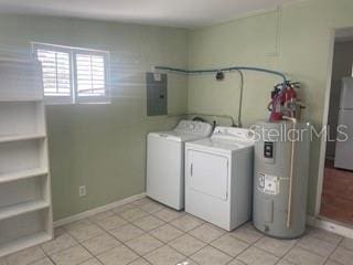 laundry room featuring light tile patterned floors, washer and clothes dryer, electric panel, and electric water heater