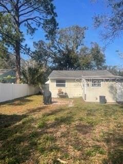 rear view of house featuring a yard