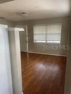 empty room featuring dark hardwood / wood-style flooring