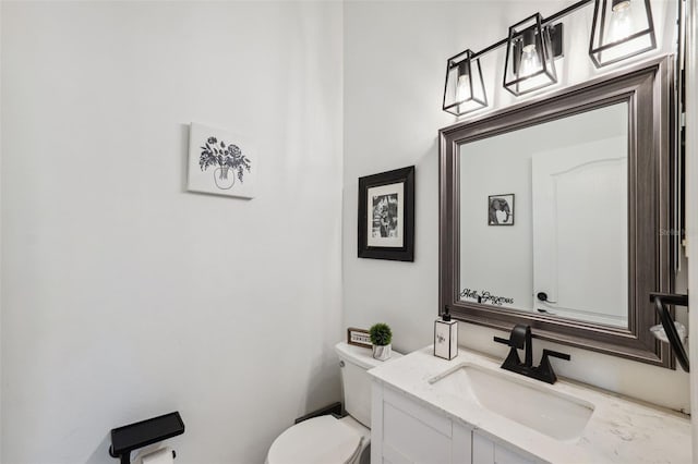 bathroom featuring toilet and vanity