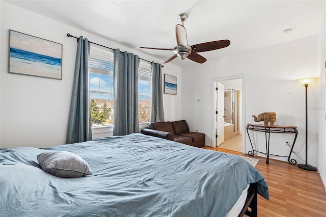 bedroom with ensuite bath, light wood-style flooring, and ceiling fan