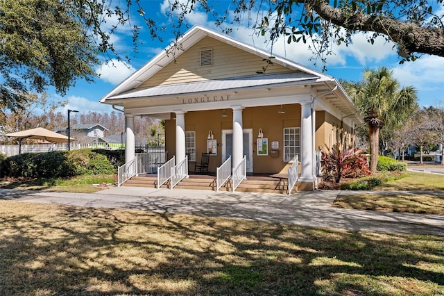 view of front of property with a front lawn, a porch, and stucco siding