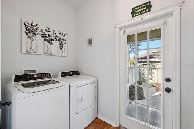 laundry room featuring laundry area, wood finished floors, visible vents, baseboards, and washing machine and clothes dryer