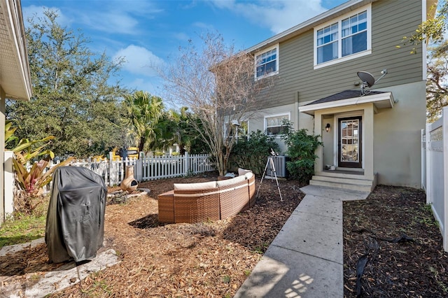 view of yard featuring a fenced backyard, an outdoor living space, and central AC