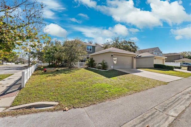 view of front of property featuring driveway, stucco siding, an attached garage, fence, and a front yard