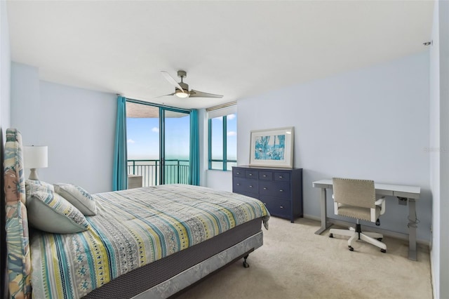 carpeted bedroom featuring a water view, ceiling fan, and access to exterior