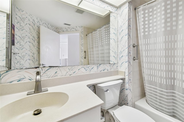 full bathroom featuring shower / bathtub combination with curtain, vanity, and toilet