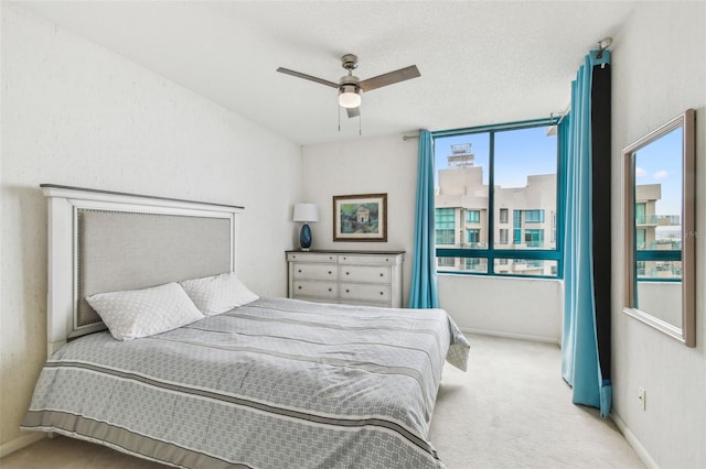 bedroom featuring ceiling fan and light colored carpet