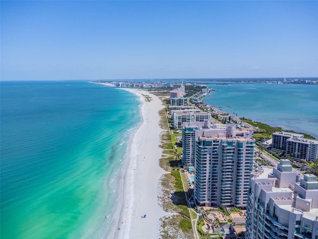 drone / aerial view featuring a water view and a beach view