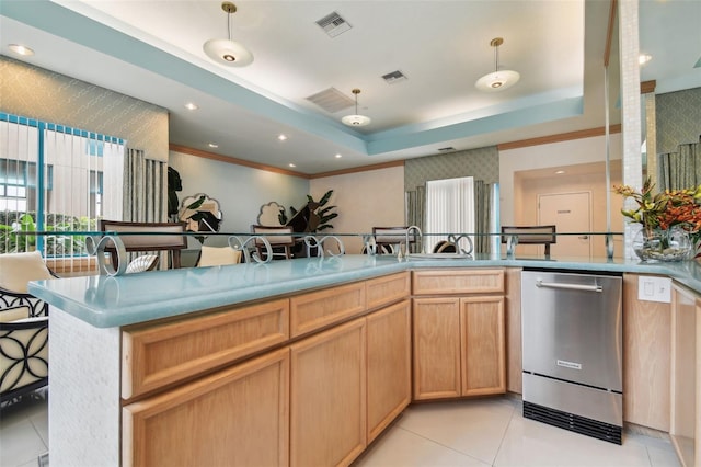 kitchen with light tile patterned flooring, decorative light fixtures, light brown cabinets, a raised ceiling, and dishwasher