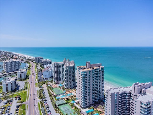 drone / aerial view featuring a water view and a beach view