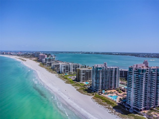 bird's eye view featuring a water view and a beach view