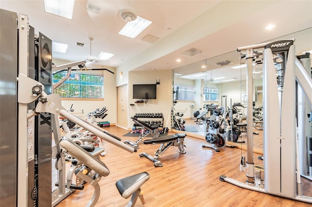 workout area with hardwood / wood-style flooring